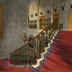 a painting of a staircase with deer heads on the wall and red carpeted stairs