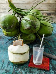 some coconuts and a glass on a table