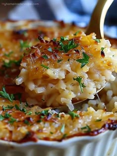 a spoon full of macaroni and cheese being lifted from a casserole dish