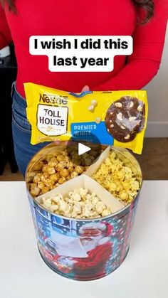 a woman holding a bag of popcorn in front of her stomach with the caption i wish i did this last year