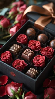 chocolates in a box with red roses on the table