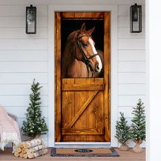 a door with a horse on it and christmas trees in the front yard behind it