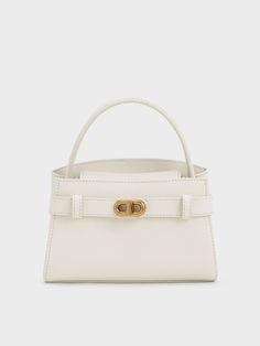 Add a dose of elegance to your outfits with our Aubrielle cream top handle bag. Featuring gilded hardware by way of the metallic buckle strap, you can count on this small-sized yet spacious bag as your trusty fashion companion. Carry it by its handle or sling the detachable bag strap across your shoulder. The perfect addition to your ever-expanding collection of new neutrals, pair it with a crochet dress and tubular mules for a simple yet sophisticated weekend look. Charles And Keith Aubrielle, Charles And Keith Bags, Charles And Keith, Chic Crossbody Bag, Cream Bags, Buckle Top, Cream Top, Cream Tops, Size Chart For Kids