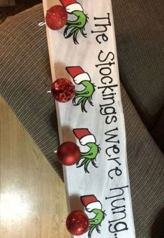 a white sign with red ornaments on it