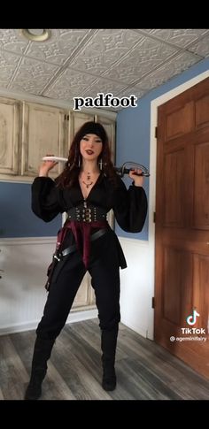 a woman dressed in pirate costume posing for the camera