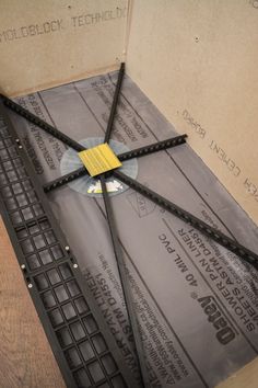 a broken computer keyboard sitting on top of a cardboard box