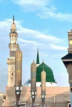 two tall buildings with green domes on top