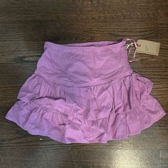 Brand New With Tags. Beautiful Pink/Purple Ruffle Mini Skirt With Cinched Waist For Adjustable Fit. Fitted Purple Skirt With Ruffles, Purple Ruffled Mini Skirt, Purple Cotton Skort For Summer, Fitted Purple Mini Skirt With Ruffles, Purple Mini Skirt For Summer, Summer Purple Cotton Skort, Purple Tiered Ruffled Skirt, Purple Mini Skirt For Spring, Flowy Purple Mini Skirt With Ruffles