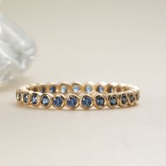 a gold ring with blue sapphire stones