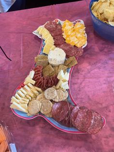 a table topped with lots of different types of cheeses and crackers on top of it