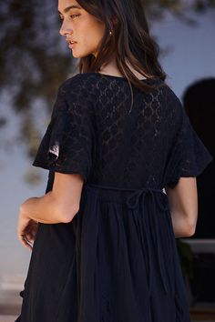 Romantic and ethereal, this sweet midi from our free-est collection is a true throw-on-and-go staple. **Fit:** Shapeless, babydoll-inspired silhouette **Features:** Square neckline, embroidered lace piecing, ruffle trimming throughout, back tie closure, flutte sleeves **Why We ❤ It:** Laid back with sporty sneakers or elevated with sleek platforms, this style has endless ways to wear. | Bring The Romance Midi Dress by free-est at Free People in Black, Size: M Sporty Sneakers, Flutter Sleeves, Embroidered Lace, Black Midi Dress, Square Neckline, Ruffle Trim, Flutter Sleeve, Boho Outfits, Summer Collection