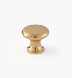 an antique brass knob on a white background