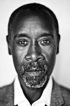 a black and white photo of a man in a suit