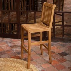 a wooden chair sitting on top of a brick floor