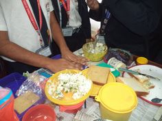 two people sitting at a table with food on it