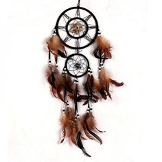 a dream catcher with feathers hanging from it's side