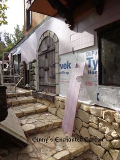 a building that has some kind of door on the outside and stone steps leading up to it