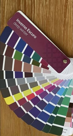 the pantoner color guide is displayed on top of a wooden table with it's matching colors