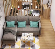 a grey couch sitting next to a coffee table