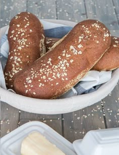 two loaves of bread in a white bowl with text overlay that reads how to make cheesecake factory brown bread