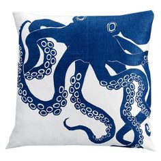 an octopus pillow with blue and white print on the front, sitting on a white surface