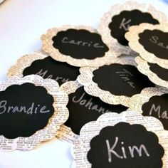 black and white labels with names on them are placed next to each other in the shape of flowers