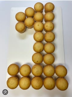 a number made out of cupcakes sitting on top of a white plate