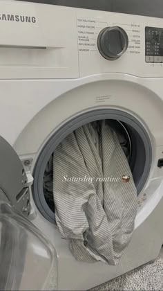 a white washing machine with the door open