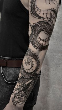 a man with a dragon tattoo on his arm