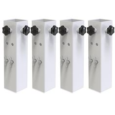 four white urinals with black knobs on each one side and three in the middle