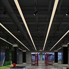 an empty gym with swings and balls on the floor