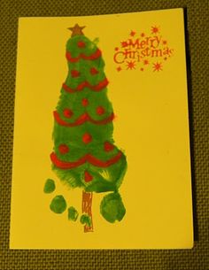 a child's handprinted christmas tree on a yellow card with red and green accents