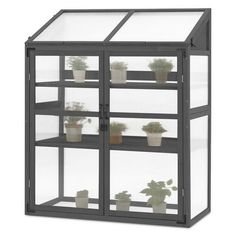 a glass case with plants in it on a white background and the bottom half is empty