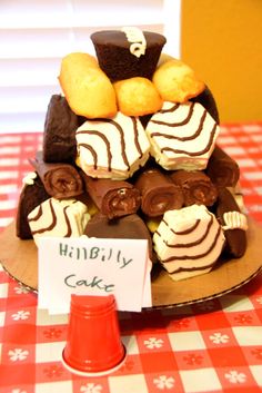 a table topped with lots of different types of cakes and pastries on top of each other