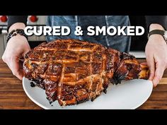 a person is holding a large piece of meat on a white plate with the words curd and smoked above it