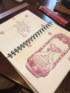 an open spiral notebook with drawings on it