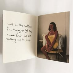 an open book with a woman sitting on a chair