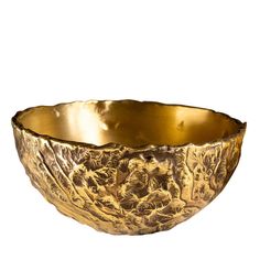 a large gold bowl sitting on top of a white surface