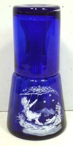 a blue glass vase with an angel on it