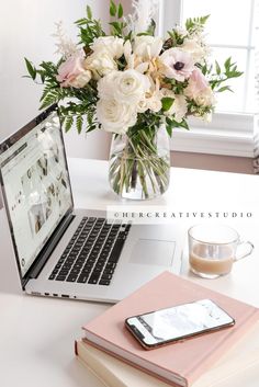 an open laptop computer sitting on top of a desk next to a cup of coffee