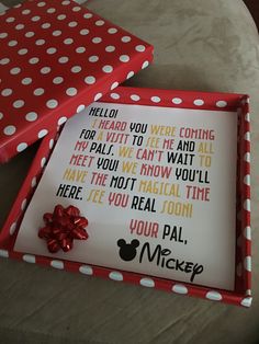 a red and white polka dot box with a card inside