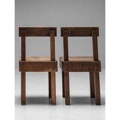 two wooden chairs sitting next to each other