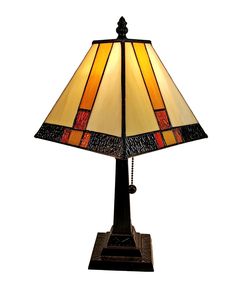 a lamp that is sitting on top of a wooden base and has a brown shade