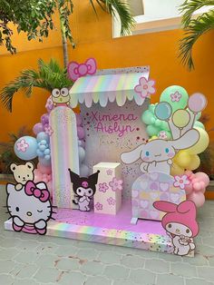 a hello kitty birthday party with balloons and decorations