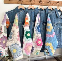 denim jackets hanging on a rack with flowers