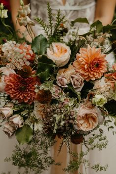 a bride holding a bouquet of flowers in her hands