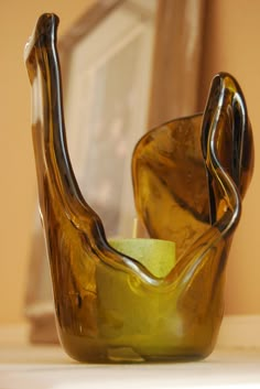 a brown glass vase sitting on top of a table