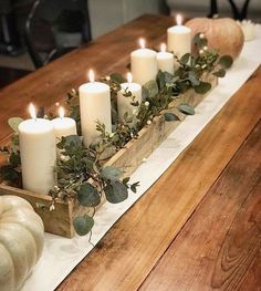 an instagram page with candles and pumpkins on the table in front of it