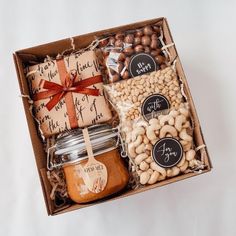 a gift box filled with nuts, crackers and cheeses for someone to eat