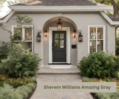 a gray house with white trim and black front door that says sheryln williams amazing gray